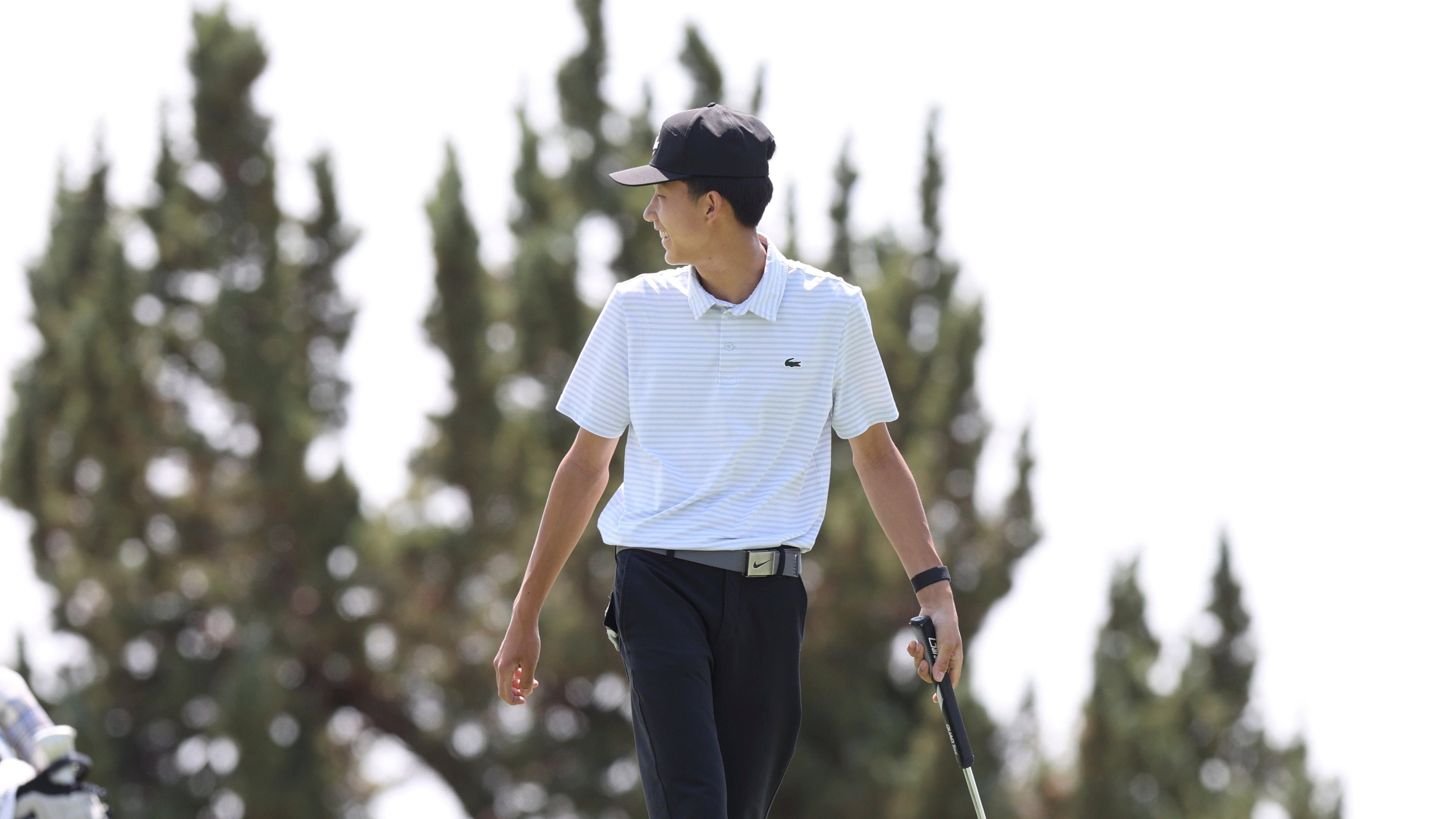 Benny
walking on a golf course with trees in the background